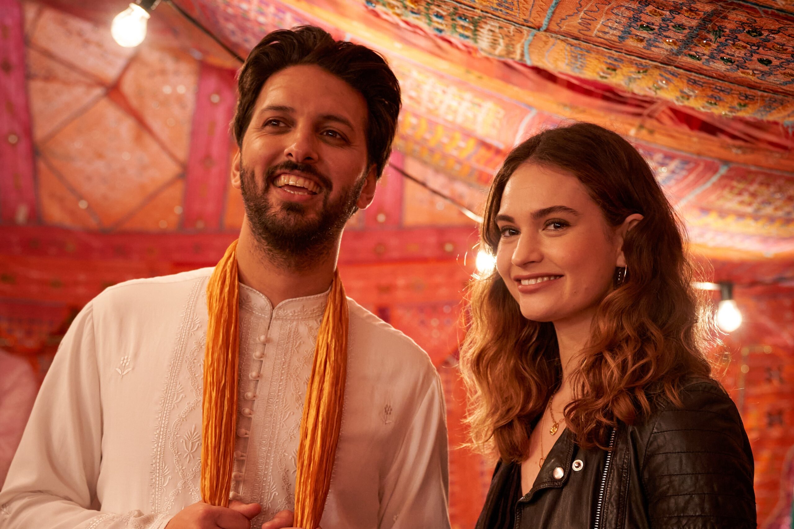Lily James as Zoe Stevenson and Shazad Latif as Kaz Khan in What's Love Got To Do With It.
