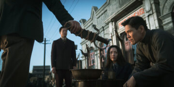 Jacky Heung as Shen sitting down staring at the hilt of a dagger in the movie 100 Yards.