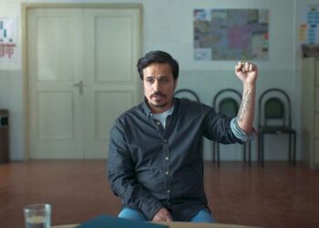 Man holding his fist up in the film Terrestrial Verses.