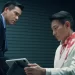 Andy Lau as George Lam holding a tablet sitting across from Eddie Peng as Eddie Fong in I Did It My Way.