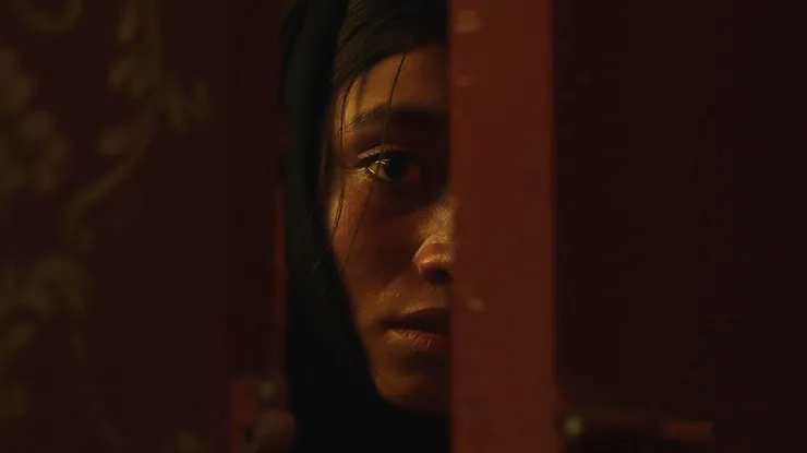 Ramesha Nawal as Mariam staring through a doorway in terror from the movie In Flames.
