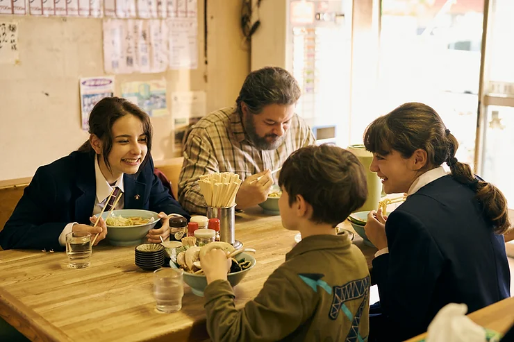 Arashi Lina as Sarya and her family eating ramen in the movie My Small Land.
