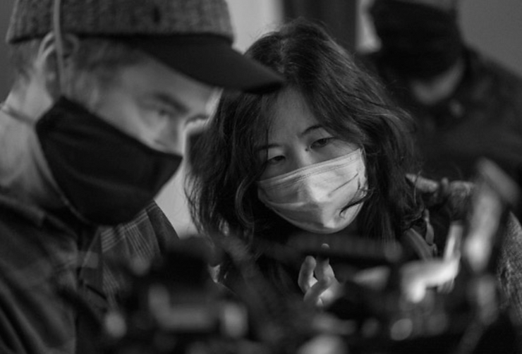 Samantha Wan operating a camera.