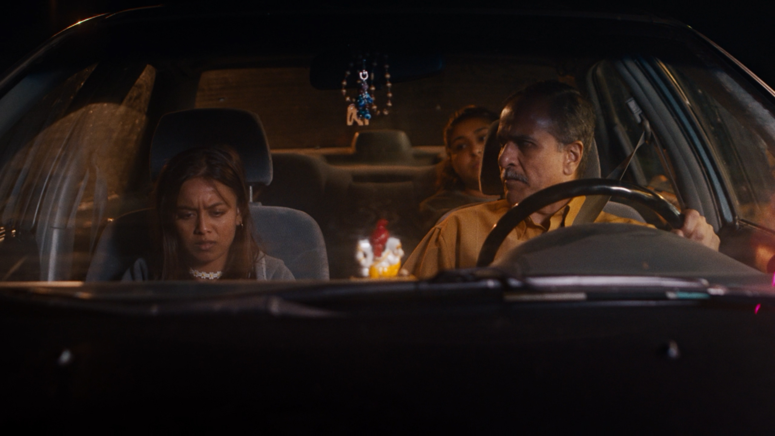 Zaarin Bushra as Pooja in the car with her family in White Elephant film