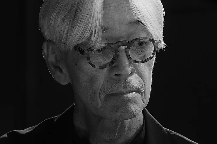 Black and white close-up of Ryuichi Sakamoto.