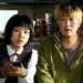 Song Kang-ho as Gang-du and Ko A-sung as Hyun-seo sitting on a couch in the movie Host.
