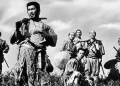 Toshiro Mifune as Kikuchiyo from Seven Samurai standing in a field in front of five other men