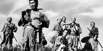 Toshiro Mifune as Kikuchiyo from Seven Samurai standing in a field in front of five other men