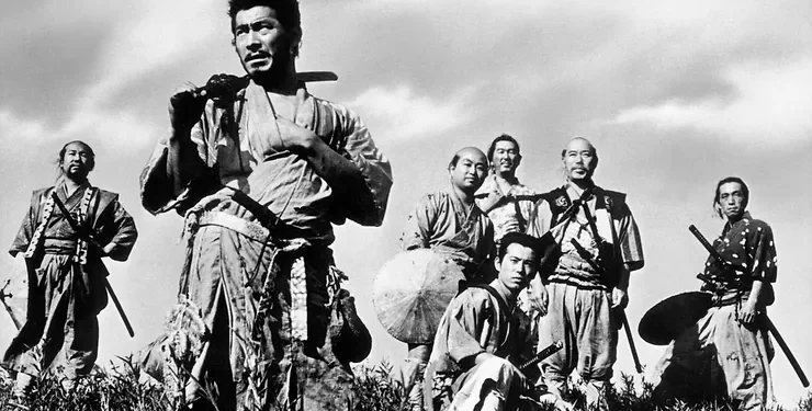 Toshiro Mifune as Kikuchiyo from Seven Samurai standing in a field in front of five other men