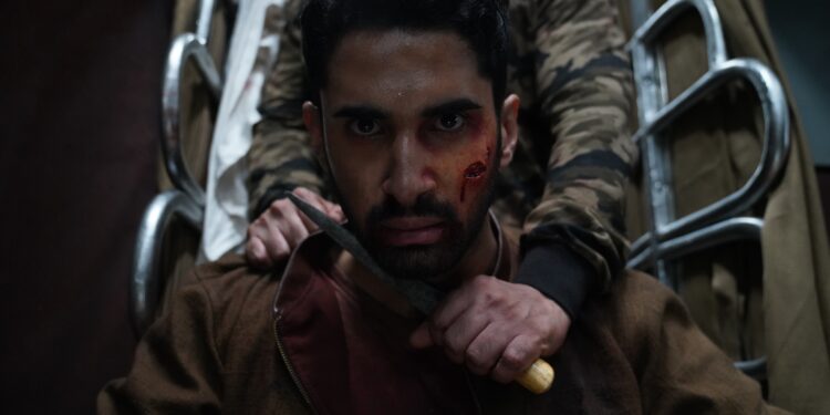 Close up of Lakysha as Amrit with a knife to his neck from the movie Kill.