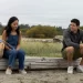 Andrea Bang as Waverly and Robbie Amell as Blake sit together on the beach in Float, directed by Sherren Lee.