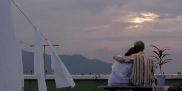 Ryu and his sister sit on a rooftop