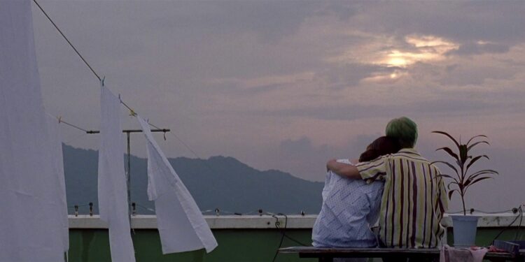 Ryu and his sister sit on a rooftop