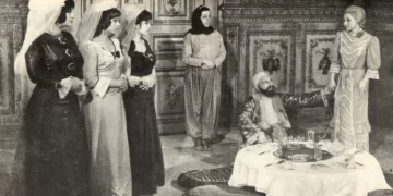 A film still from Ver Elini Istanbul showing several characters gathered in a dining room.