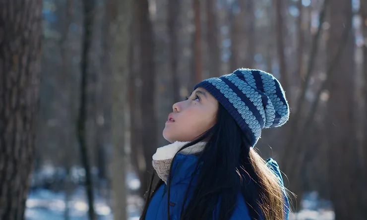Ryo Nishikawa as Hana standing in the woods staring up in Drive My Car.