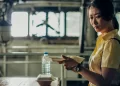 A tear rolls down Zhao Tao's face as she holds a takeout container of rice in Caught by the Tides.