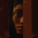 Ramesha Nawal as Mariam staring behind a door from the movie In Flames.