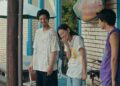 Hiroki Sano as Sano standing with two friends in front of a house laughing in Super Happy Together.