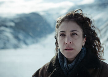 Vishka Asayesh as Maryam standing on top of a snowy mountain in Seven Days.