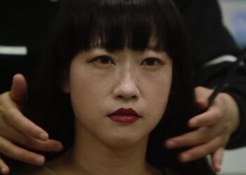 Close up of an Asian woman seated at the hairdresser in Elizabeth Lo's documentary Mistress Dispeller