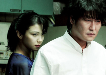 Tae-ju (Kim Ok-bin) stands behind Sang-hyun (Song Kang-ho) in Park Chan-wook's 2009 film "Thirst."