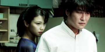 Tae-ju (Kim Ok-bin) stands behind Sang-hyun (Song Kang-ho) in Park Chan-wook's 2009 film "Thirst."