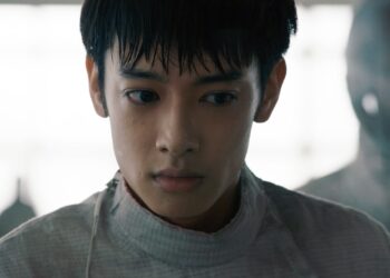 A medium close-up of Liu Hsiu-Fu as Zijie in Pierce, dressed in a white fencing uniform.