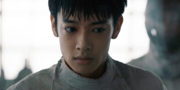 A medium close-up of Liu Hsiu-Fu as Zijie in Pierce, dressed in a white fencing uniform.