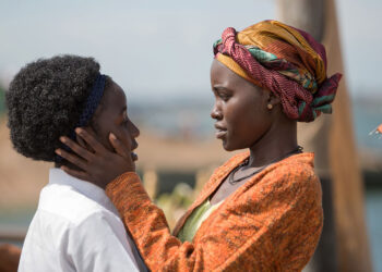 Lupita Nyong'o as Nakku Harriet embracing Madina Nalwanga as Phiona Mutesi in Queen of Katwe