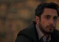 Riz Ahmed as Changez Khan staring off in the distance in The Reluctant Fundamentalist.