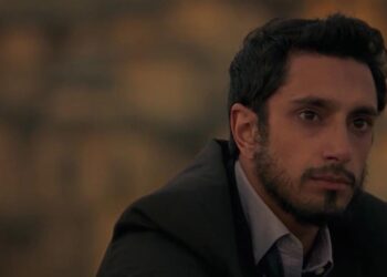 Riz Ahmed as Changez Khan staring off in the distance in The Reluctant Fundamentalist.