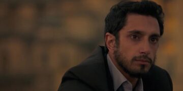 Riz Ahmed as Changez Khan staring off in the distance in The Reluctant Fundamentalist.