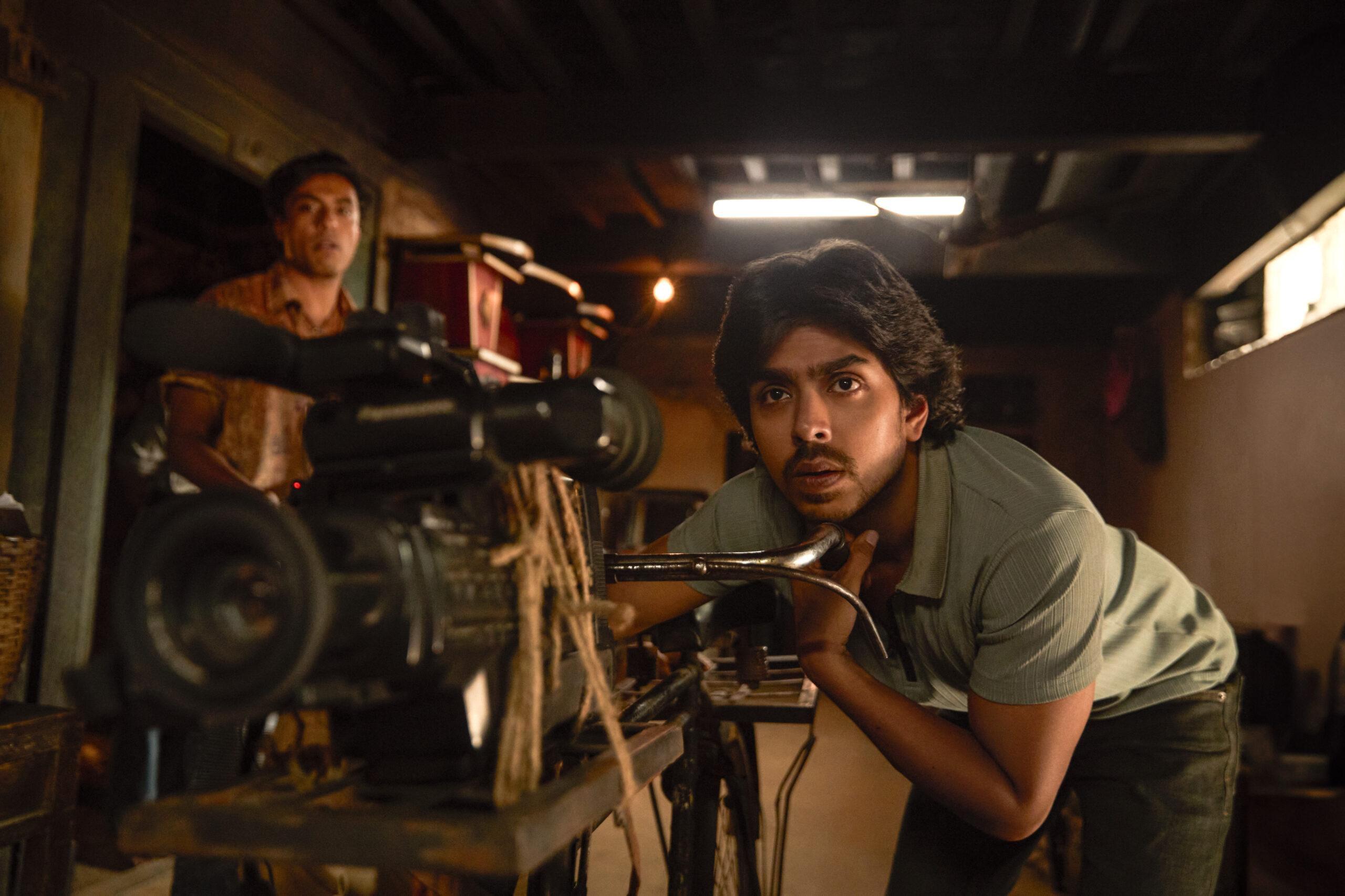 Adarsh Gourav as Nasir directing behind a camera in Superboys of Malegaon