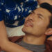 Henry Golding as Nicholas laying in the lap of his partner in Daniela Forever