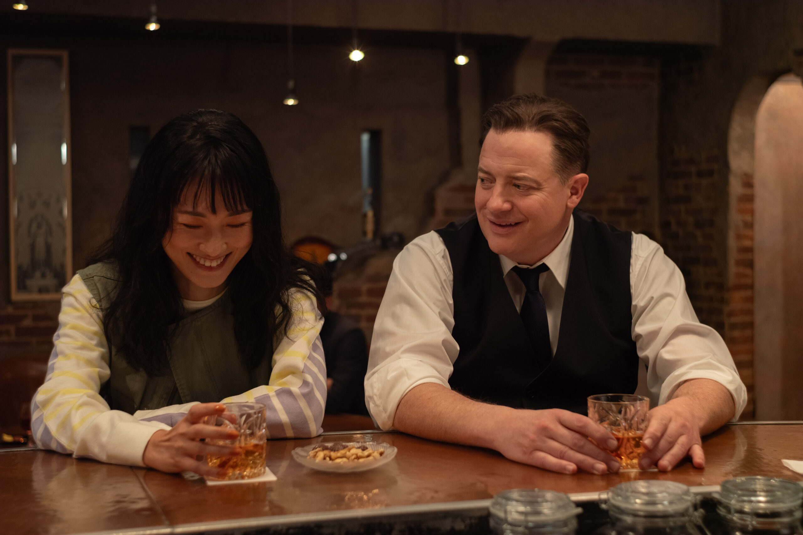 Mari Yamamoto and Brendan Fraser having a drink at a bar in Rental Family