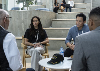 Meaghan Rath as Anushka Bhattachera-Phister and Curtis Lum as Tim Kwan sitting at a table in The Audacity