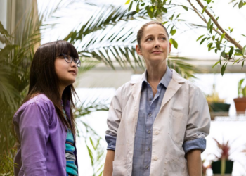 Lexi Perkel as Callie and Judy Greer as Mrs. G standing together inside a greenhouse in Mabel