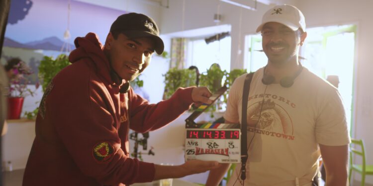 Directors Rish and Kanish holding a clapper on the set of their movie Namaslay.