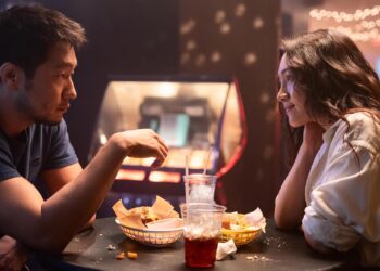 Audrey (Moon Choi) and Eli (Son Sukku) having a meal, sitting across from each other in the movie Bedford Park
