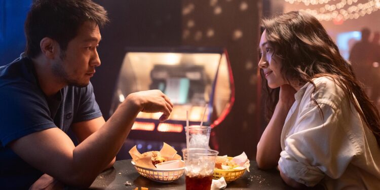 Audrey (Moon Choi) and Eli (Son Sukku) having a meal, sitting across from each other in the movie Bedford Park