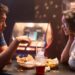 Audrey (Moon Choi) and Eli (Son Sukku) having a meal, sitting across from each other in the movie Bedford Park