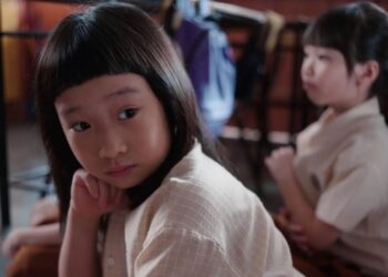 Ong Xuan Jing as Ah Girl sitting in a classroom in Ah Girl.