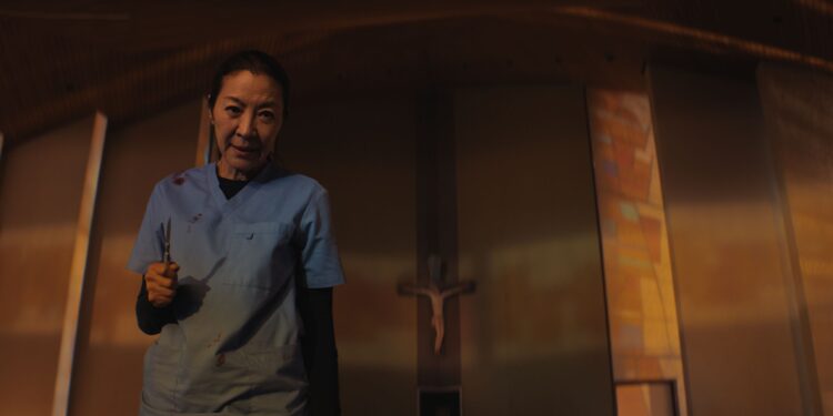 Michelle Yeoh as the Surgeon holding a scalpel in The Surgeon